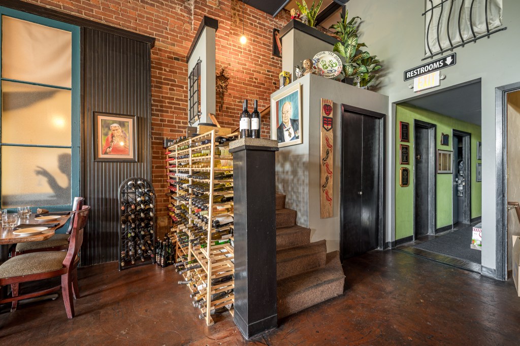 Staircase along brick wall