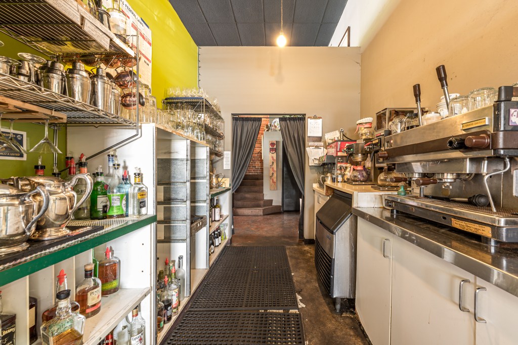 Prep area including ice machine with rubber mats on floor
