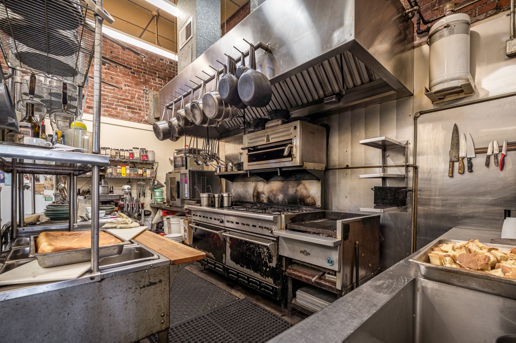 Commercial kitchen with ranges, posts and pans