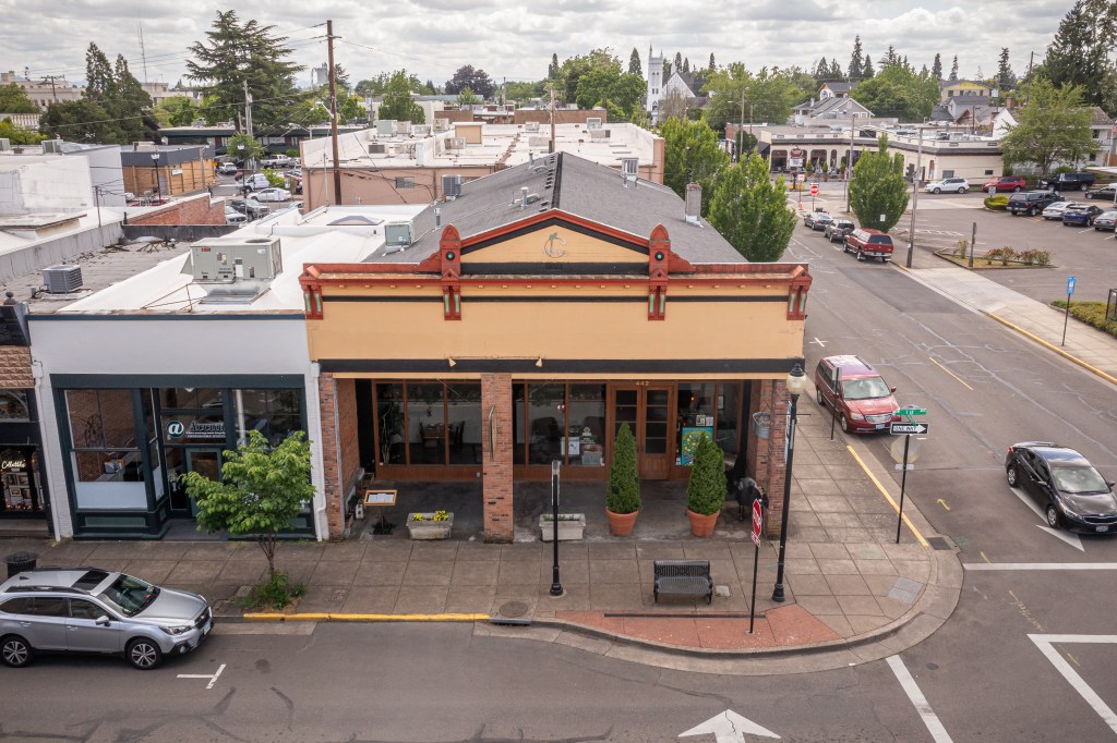 Low aerial photo of front of brown building