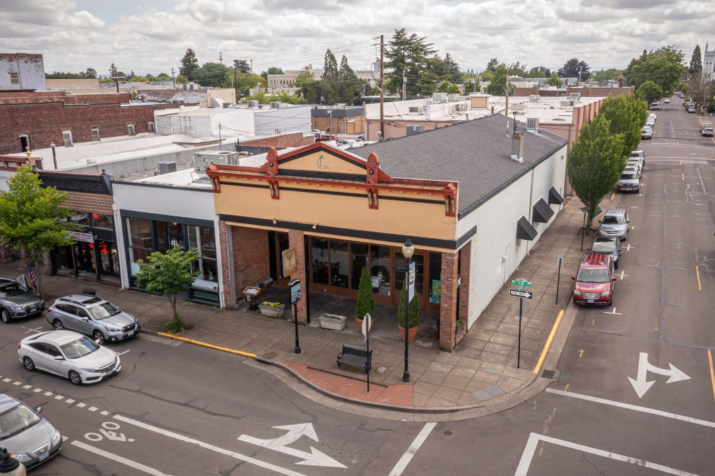 Low aerial of front of building and white side of building