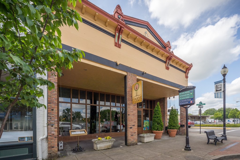 Front of tan building with closer look at covered outdoor dining area
